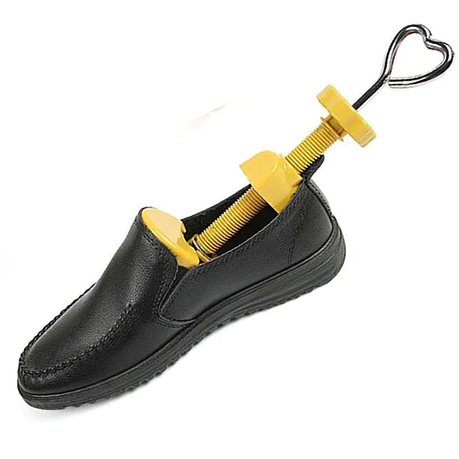 Black leather loafer with yellow adjustable shoe stretcher tool inside