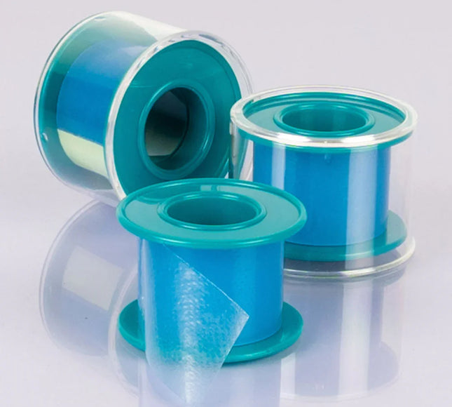 Three blue adhesive tape rolls with transparent edges on a reflective surface